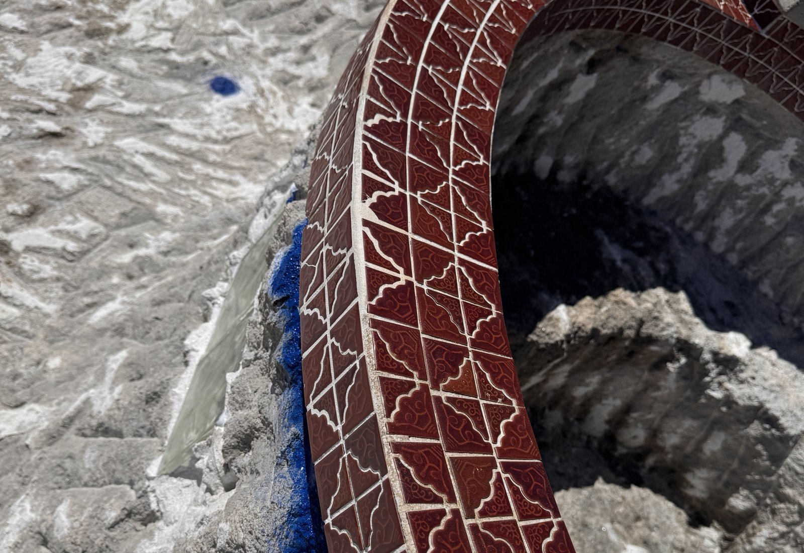 Tile cleaning on a red patterned spa, after
