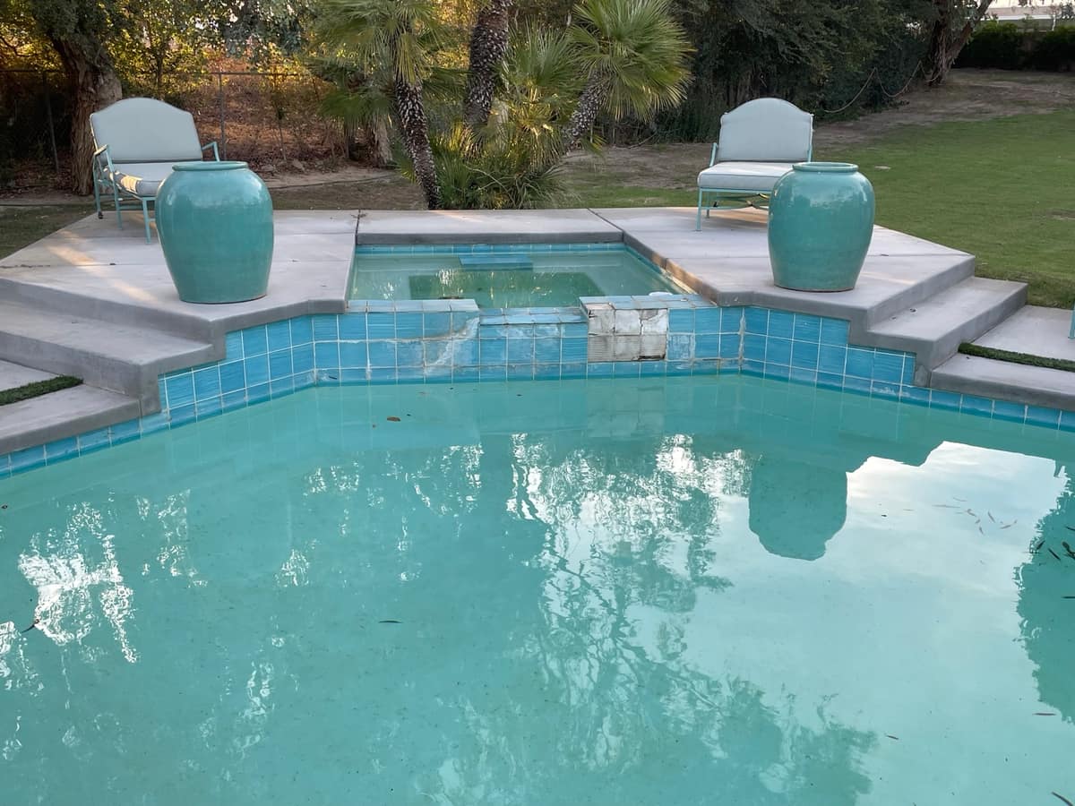 Tile repair on a raised spa wall, before