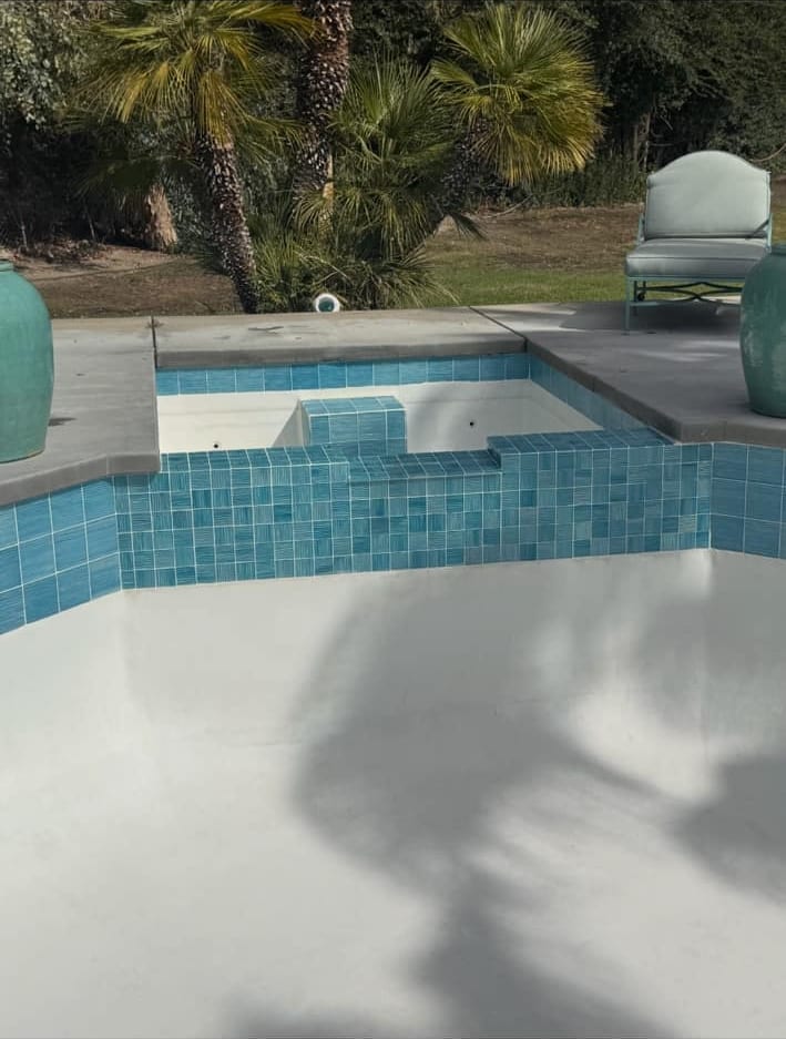 Tile repair on a raised spa wall, finished